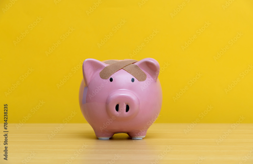 Piggy bank with adhesive bandage Piggy bank with adhesive bandage