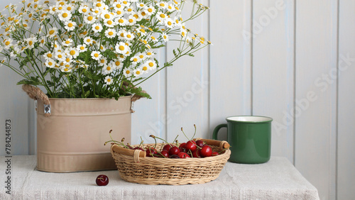 flowers and berries on the table, rural still life. cherries and daisies. cottage core.