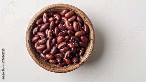 Top view of a bowl of Borlotti beans on a clean surface with a big space for text or product advertisement on a studio white surface, Generative AI. photo