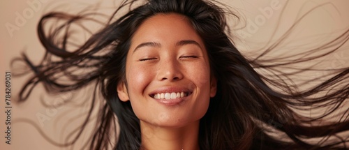 A radiant woman with flowing hair and a bright photo