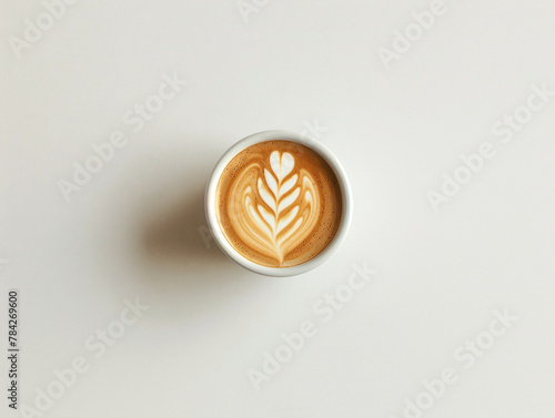 Photo of coffee cup from above with beautiful pattern. White background