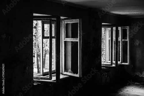 Old abandoned building. Old windows. Abandoned hotel. Peeling walls of the room. Horror concept. black and white photo