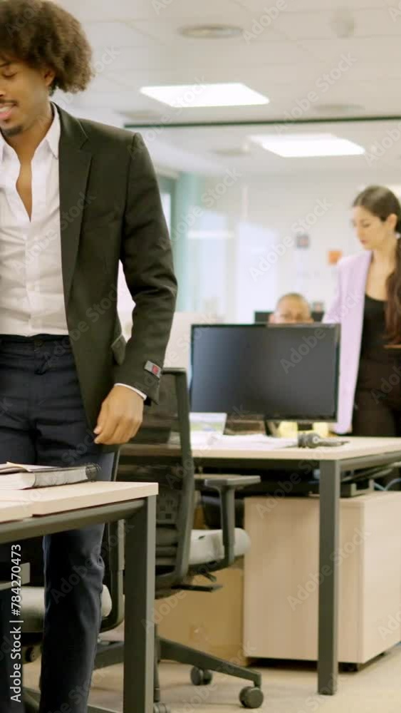 Coworkers standing up and leaving the office Coworkers standing up and leaving the office