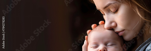 a mother gently caresses her newborn baby's head with gentle love and tenderness photo