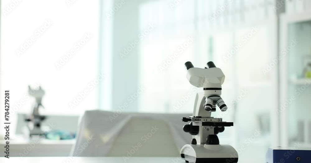 Modern medical research laboratory with microscope and test tubes with biochemical substances on the table Modern medical research laboratory with microscope and test tubes with biochemical substances on the table