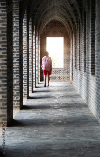 Woman walking on long corridor