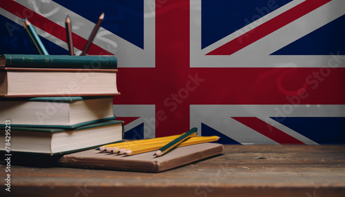 Books and pencils in classroom on the background of the United Kingdom flag. Concept of education, back to school