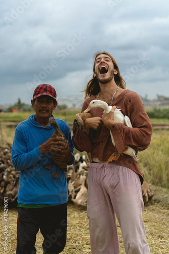 European man with local Indonesian farmer. photo