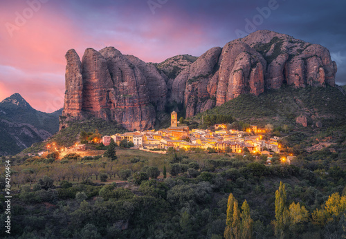 Aguero Village and Mallos de Aguero Rock Formation at Sunset, Spain photo