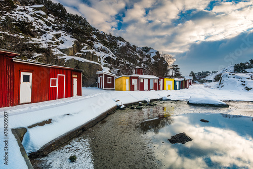 Colorful Sea Cottages Against a Snowy Landscape in Sweden During Winter