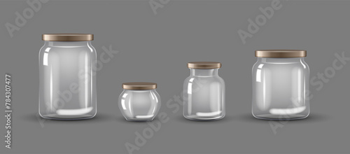 Set of empty transparent glass jars with caps