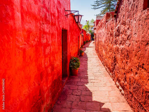 Beautiful alley in the ancient Santa Catalina monastery with bright red walls, Arequipa, Peru