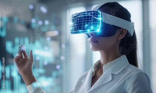 Young female doctor studying at intern practice using futuristic VR technology glasses with medical digital overlay in front of her.