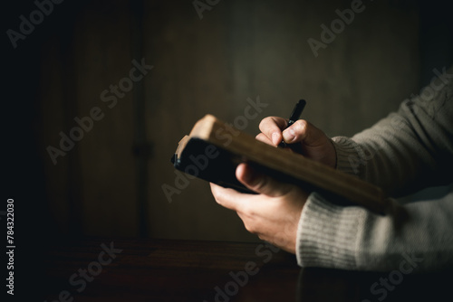 Man with holy bible in his hand  ready to pray  seek guidance from God through religious prayer. Person man  turned to God in prayer  demonstrating their religious faith and devotion through worship.