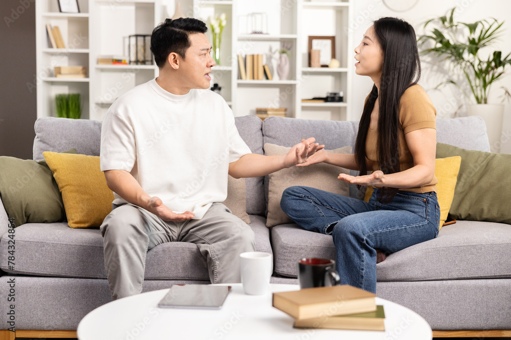 A peaceful couple sits on a couch practicing mindfulness meditation together, creating a serene atmosphere in a well-lit living room. A peaceful couple sits on a couch practicing mindfulness meditation together, creating a serene atmosphere in a well-lit living room.