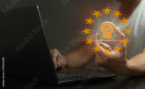 A person is holding a laptop with a gold star on it