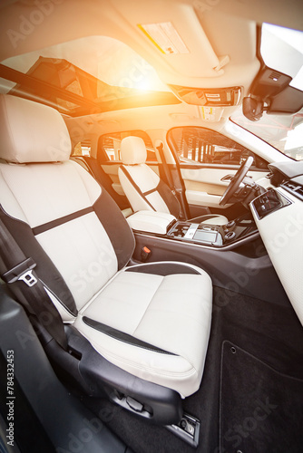 Modern luxury prestige car interior, dashboard, steering wheel. Orange red car interior. photo