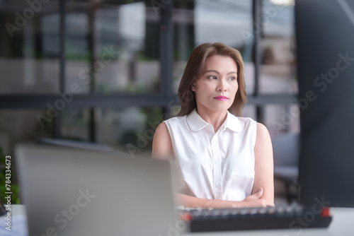 Asian businesswomen looking outside to resting with feeling tired and stressed while analyze investment market stock of new startup and using technology to working about planning of marketing report