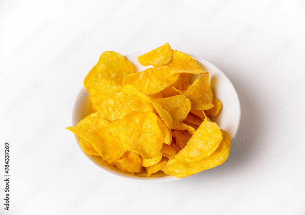 A bowl of chips is sitting on a white background. The chips are yellow and appear to be crunchy A bowl of chips is sitting on a white background. The chips are yellow and appear to be crunchy