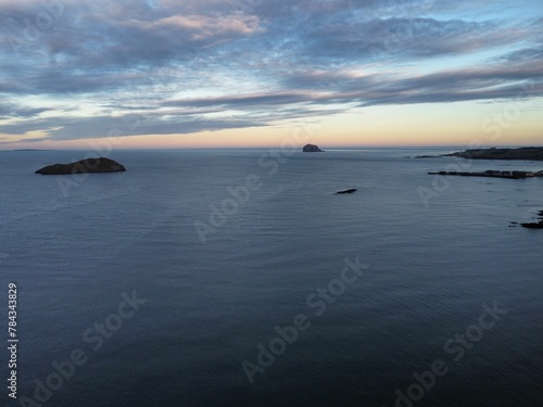 Photography Aerial view of a magnificent and idyllic sea coast in summer in the evening