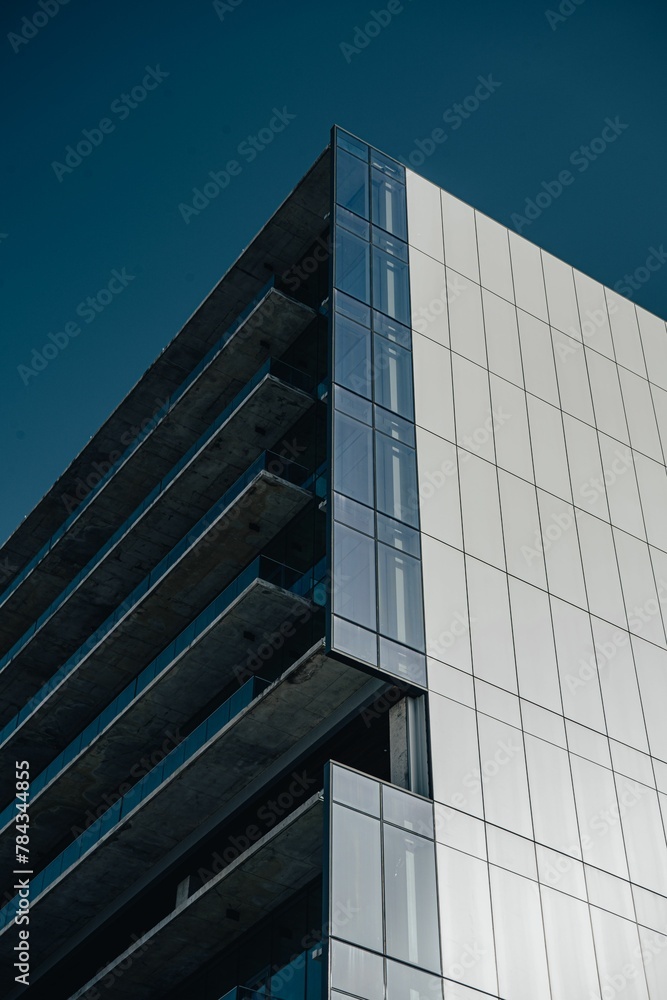 the facade of the building with clear windows and steel cladding the facade of the building with clear windows and steel cladding