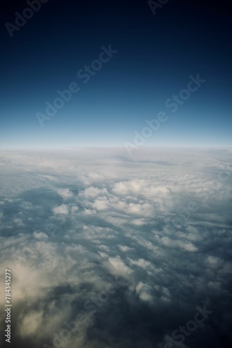 Vertical shot of the white fluffy clouds in he sky