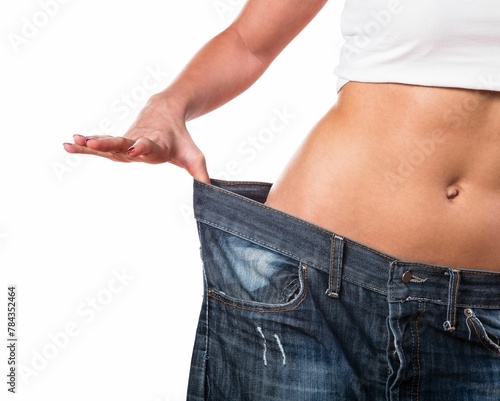 Fit girl stretching her jeans, demonstrating a large gap around her hips after weight loss