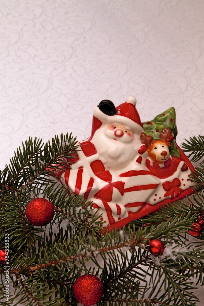 New Year's composition from a faience figurine of Santa Claus and fir branches. New Year's composition from a faience figurine of Santa Claus and fir branches.