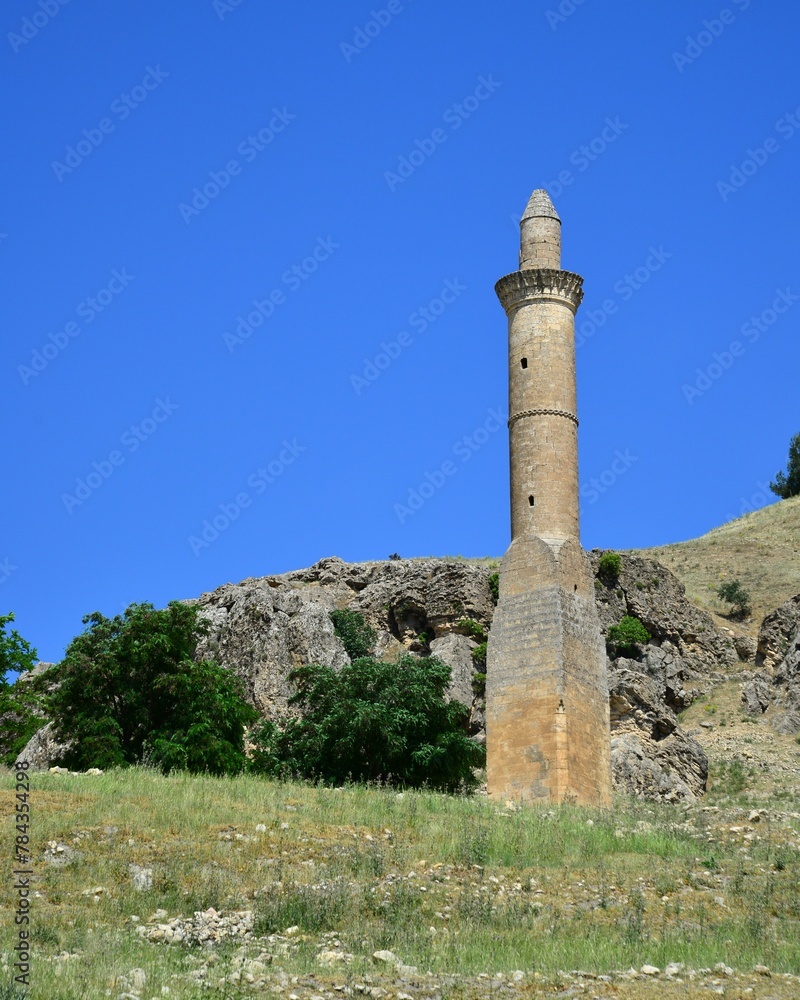 Vertical shot of an old stone tower with a blue sky in the background, Turkey