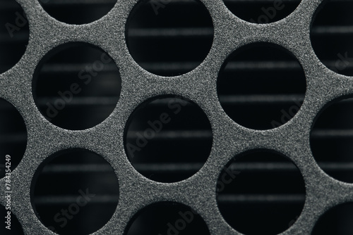 Closeup of metal holes on a black background