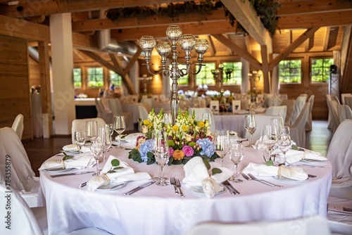 Interior view of a restaurant with a table decorated with flowers for a wedding occasion