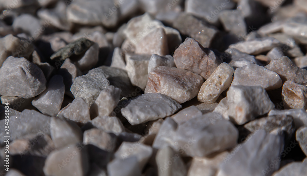 Crushed stone close-up. Texture of road building material made of crushed stone. Small stone building material. Garden gravel background, stone landscape design. Crushed stone close-up. Texture of road building material made of crushed stone. Small stone building material. Garden gravel background, stone landscape design.