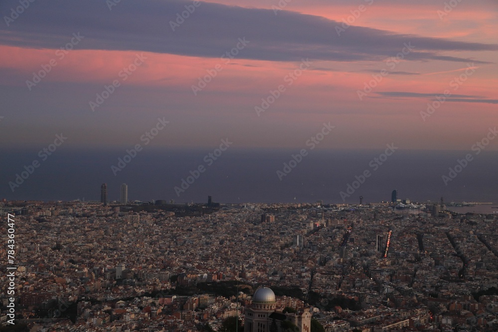 Aerial shot of the cityscape of Barcelona, Spain at sunset