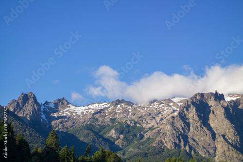 Snow melting on the peaks of mountains in the Andean mountain range on a sunny day in Argentina