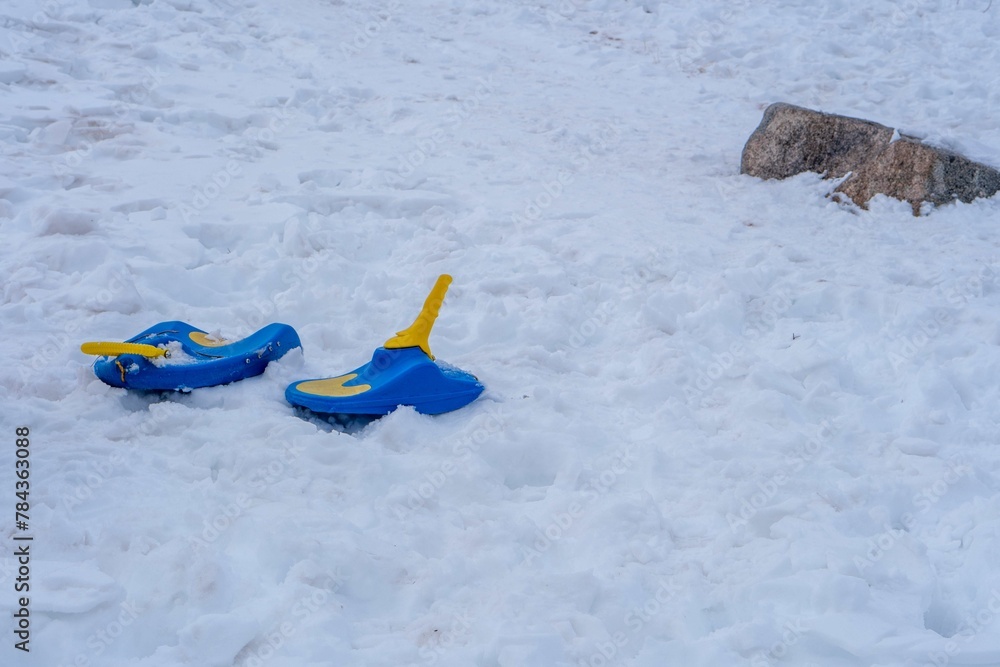 Image of two blue snow shoes in the snow. Image of two blue snow shoes in the snow.