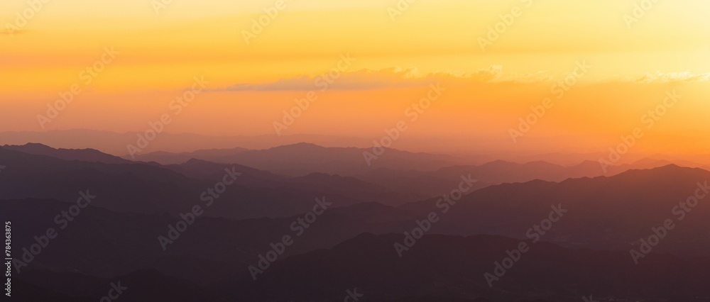 Beautiful view of a sunrise over the silhouettes of the mountain range