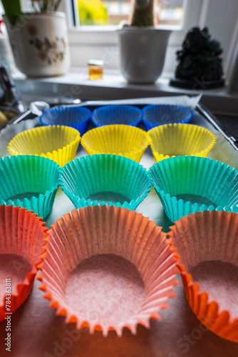 A variety of colorful cupcake liners arranged on a table for baking