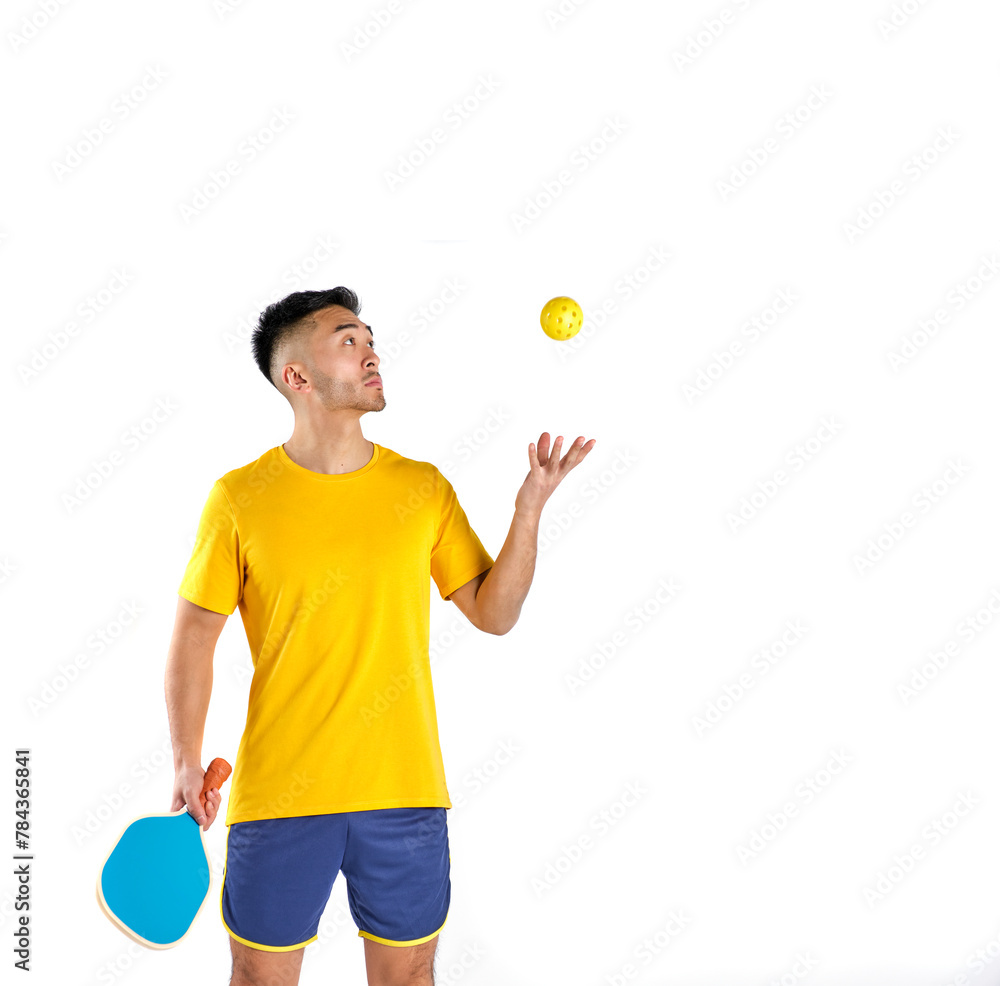 young oriental man in sportswear with paddle and pickleball ball on white background young oriental man in sportswear with paddle and pickleball ball on white background