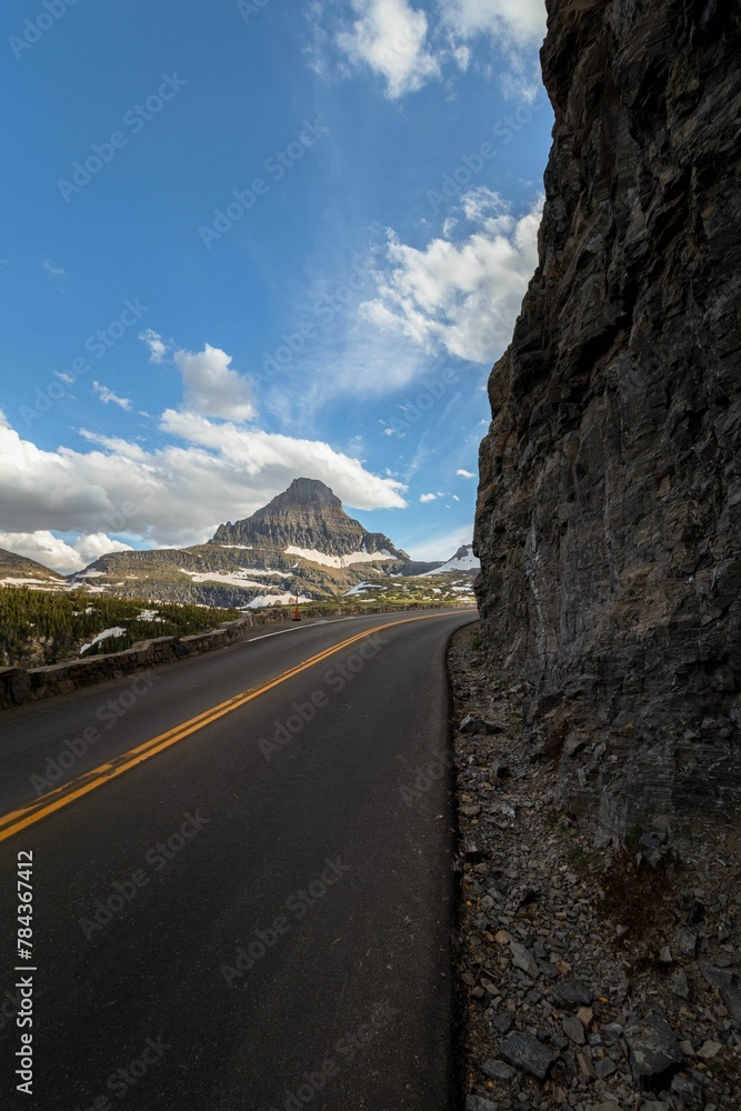 Scenic view of an asphalt road passing through the Glacier National Park