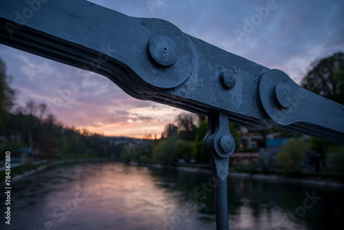 Glowing sunset over the Aare river with the bridge chain in front photo