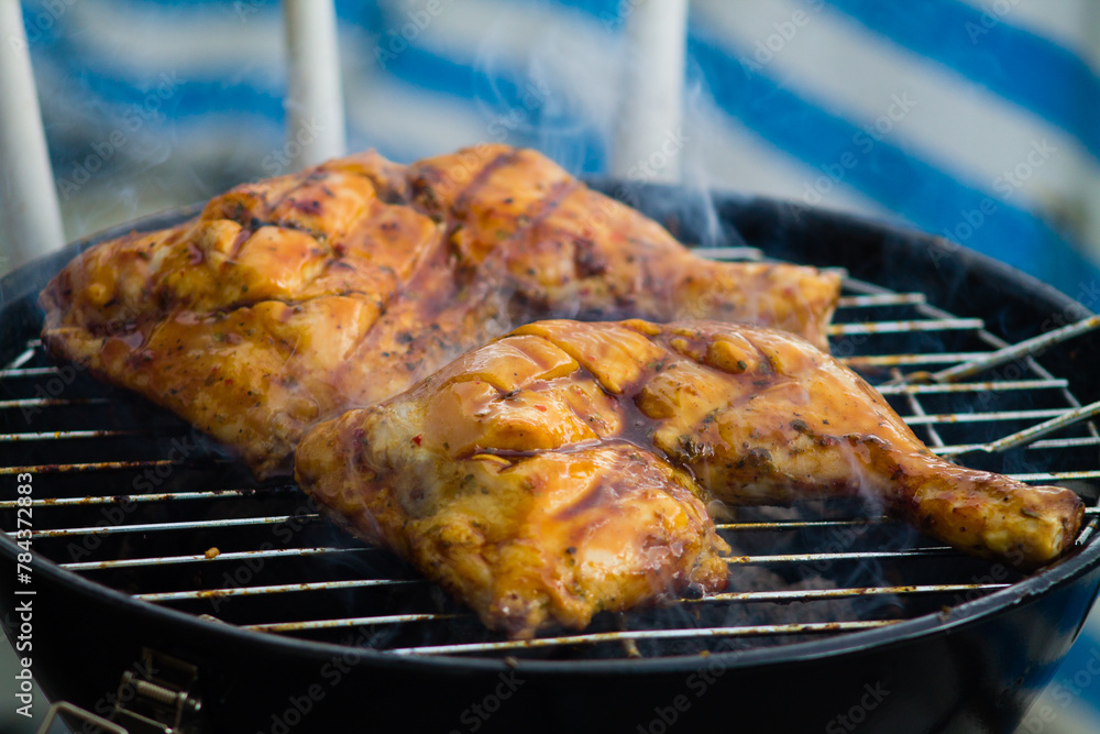 Closeup shot of a barbecue chicken on grill Closeup shot of a barbecue chicken on grill
