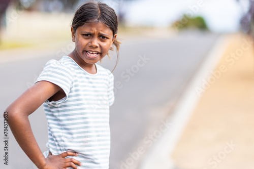 girl with hand on hip looking confused photo