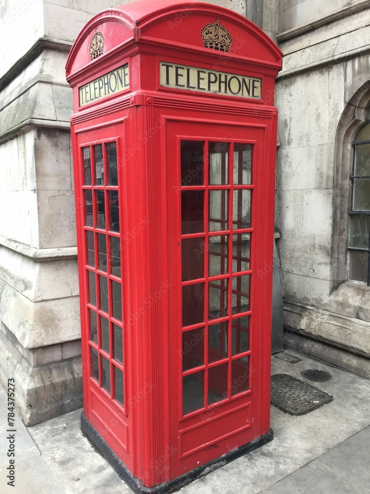 Vertical shot of a traditional red telephone box in London, UK Vertical shot of a traditional red telephone box in London, UK