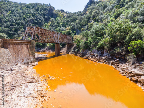 The Salomon Bridge crossing the red river, Rio Tinto, is a railway bridge in the province of Huelva and was originally part of the Riotinto railway for the transportation of copper mineral to Huelva photo