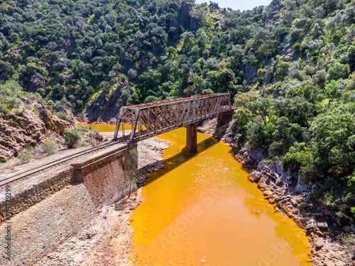 The Salomon Bridge crossing the red river, Rio Tinto, is a railway bridge in the province of Huelva and was originally part of the Riotinto railway for the transportation of copper mineral to Huelva photo