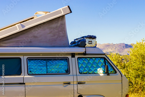 Camper van with roof top tent camp on nature