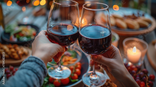 Hands raising wine glasses in a sunny outdoor feast with friends.