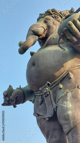 The Ganesha statue holding a banana, symbolizing nourishment and sustenance, Thailand. photo