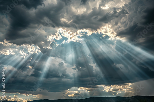 Dramatic Sun Rays Through Cloudy Sky. Crepuscular rays shine through dramatic clouds over tranquil landscape.