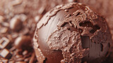 A chocolate globe spinning on a bed of cocoa nibs.